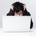iStock_000016115404XSmall bored depressed young man with laptop