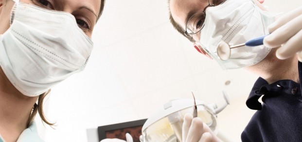 shutterstock_2092494 Dentist and assistant are examining you the patient
