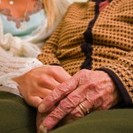 shutterstock_25879933 old woman social worker holding hands