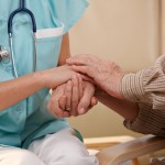 shutterstock_50920687 nurse and elderly patient holding hands