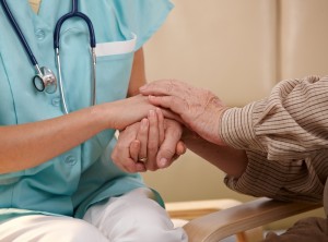 shutterstock_50920687 nurse and elderly patient holding hands