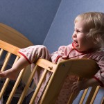 Crying young child in cot