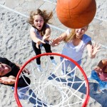 Teenagers playing basketball