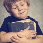 Boy hugging a book