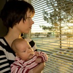 Mother and baby looking out window