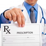 Doctor holding up a prescription form