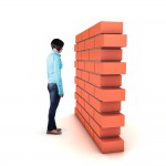 Person facing a brick wall