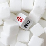 Sugar lumps with a dice in the middle with the options of yes or no