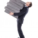 Man carrying pile of paving stones