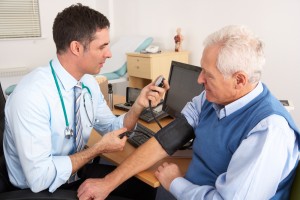 Doctor taking blood pressure measurement from a patient