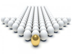 White balls in the shape of an arrow with a gold ball at the top