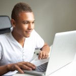 Teenage boy using laptop