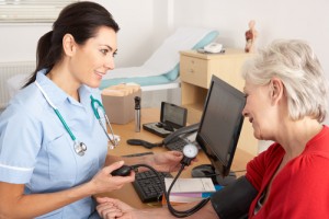 British nurse taking the blood pressure of a patient