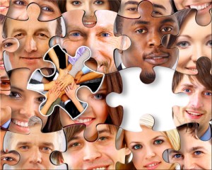 Lots of jigsaw puzzle pieces with peoples' faces on them