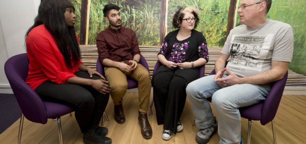 A group therapy session takes place.