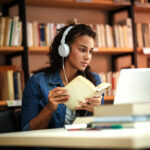 Young,Female,Student,Study,In,The,School,Library.she,Using,Laptop