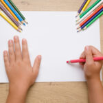 Little,Girl's,Hand,Painting,On,The,White,Paper,With,Pink