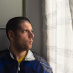 Headshot,Of,A,Young,Man,Looking,Sad,At,The,Window