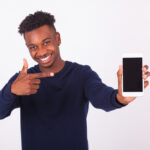 Young African American man pointing his  smartphone screen - Black teenager people