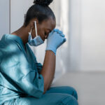 Tired,Depressed,Female,African,Scrub,Nurse,Wears,Face,Mask,Blue