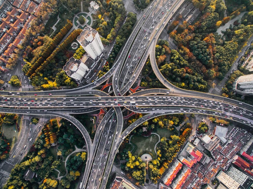 A shot from the air of four several lane highways coming to an intersection with each other, creating a cross shape
