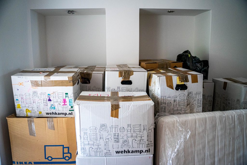 Lots of moving boxes gathered in an empty room