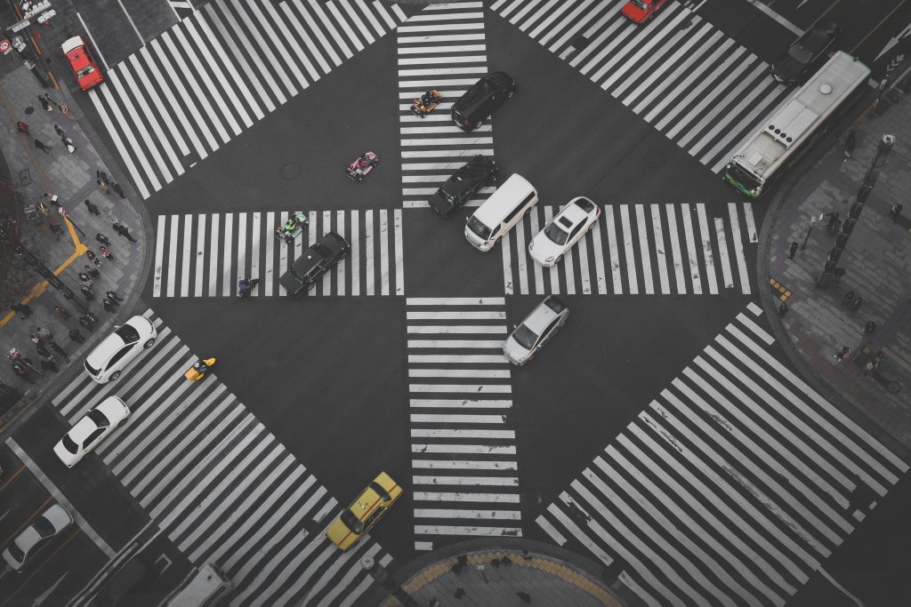 a busy four way intersection, viewed from above