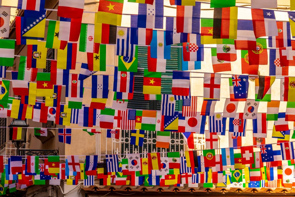 Tens of flags from all round the world and in all different colours hang from the ceiling