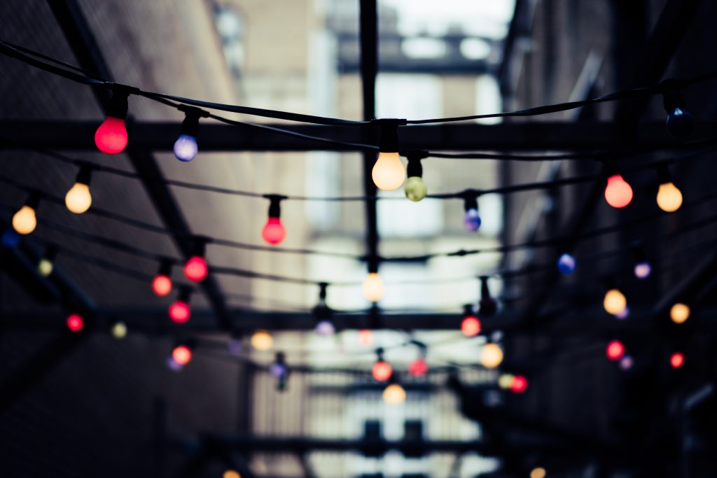 big bulb fairy lights hang from above
