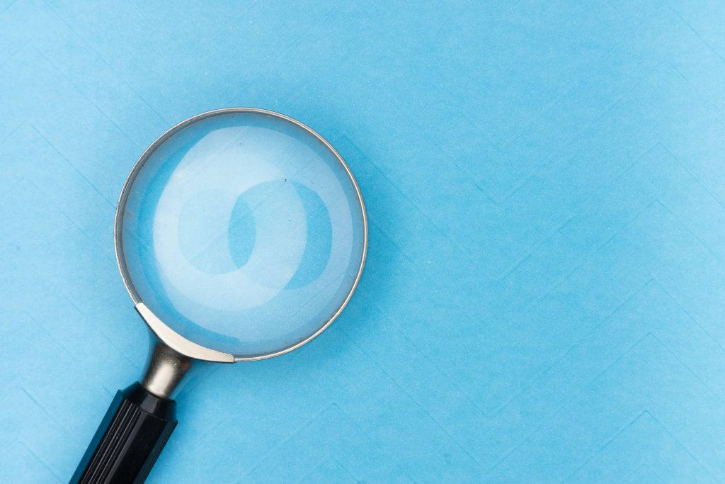 a magnifying glass over a blue background