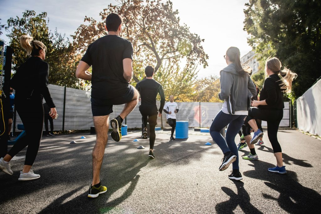 a group of people are taking part in an exercise class outside