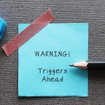 Blue,Stick,Note,With,Handwritten,Text,Warning!,Triggers,Ahead,-