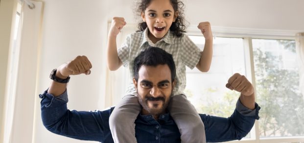 Cheerful,Strong,Indian,Dad,Lifting,Little,Daughter,Kid,On,Shoulders,