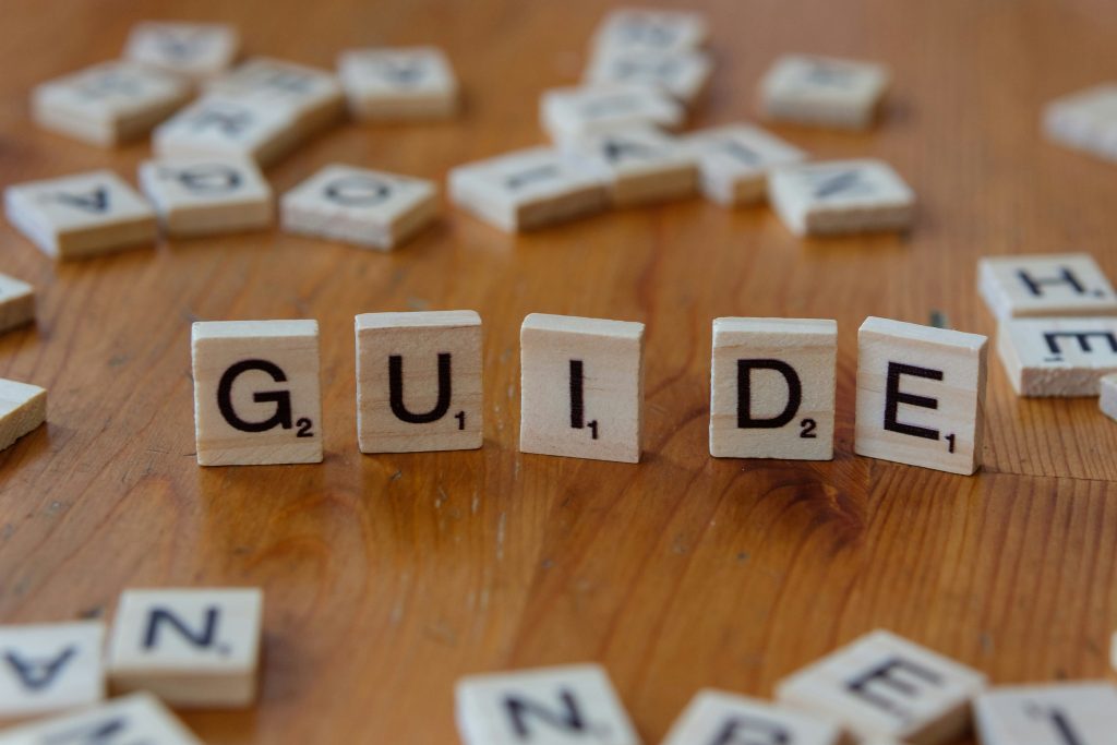 Scrabble letters spell out the word guide