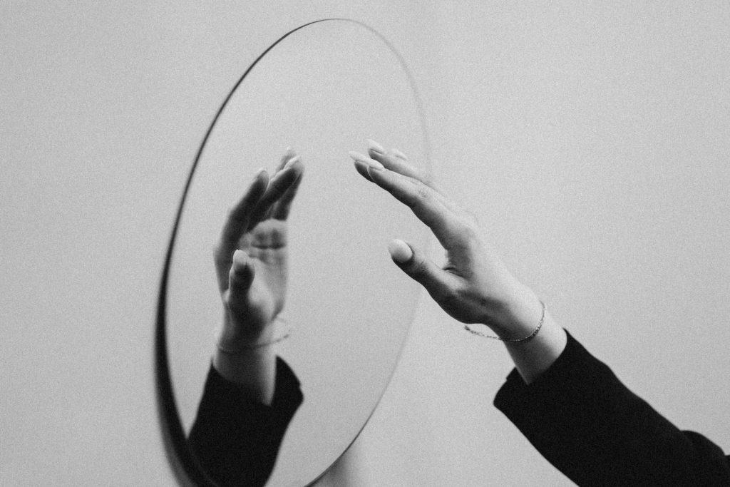 A hand reflected in a mirror