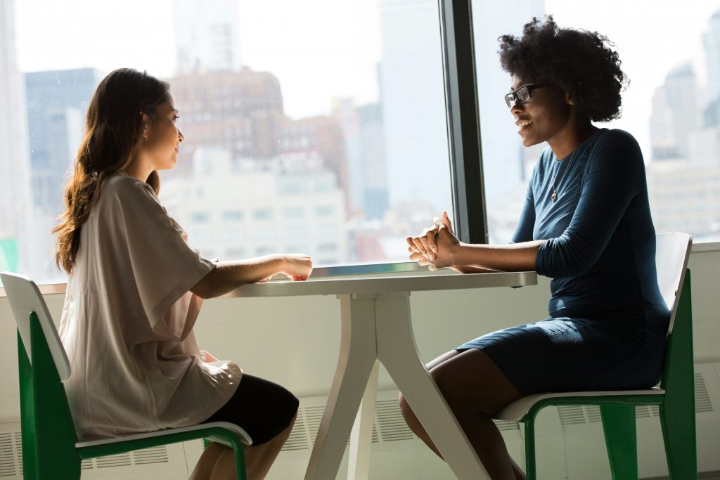 Two people at a table in conversation