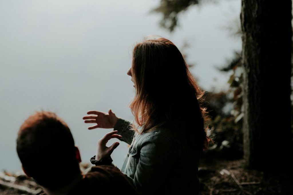 Person talking to someone else and gesticulating with their hands