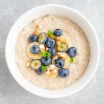 Bowl,Of,Oatmeal,Porridge,With,Banana,,Blueberries,And,Almonds,On
