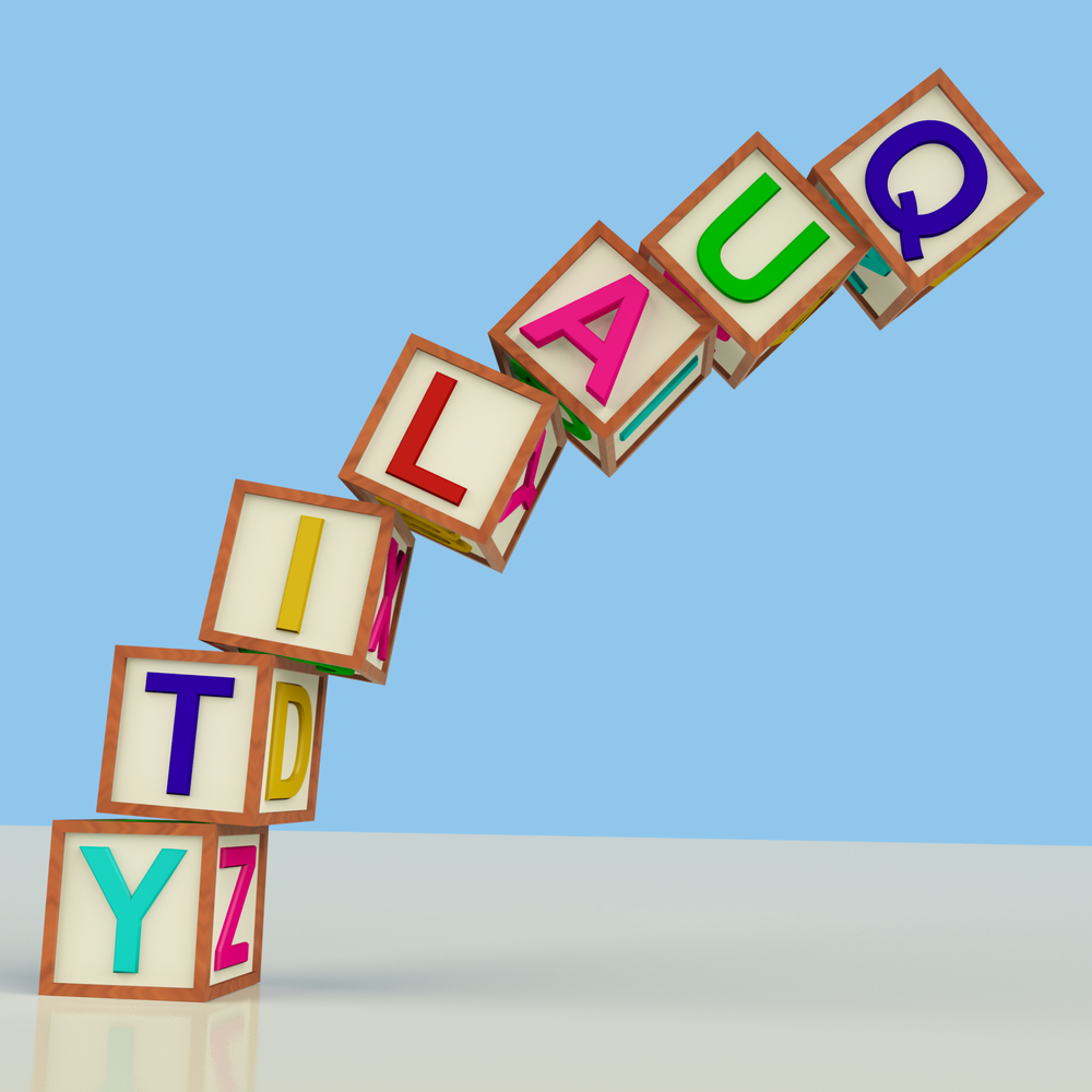 Wooden bricks spelling quality and toppling over