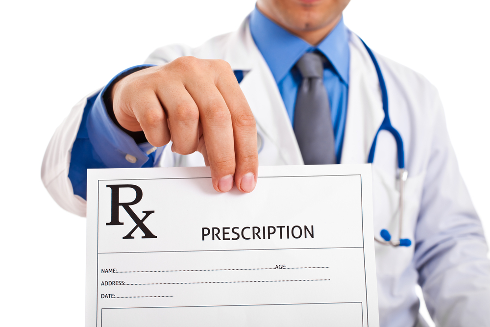 Doctor holding up a prescription form