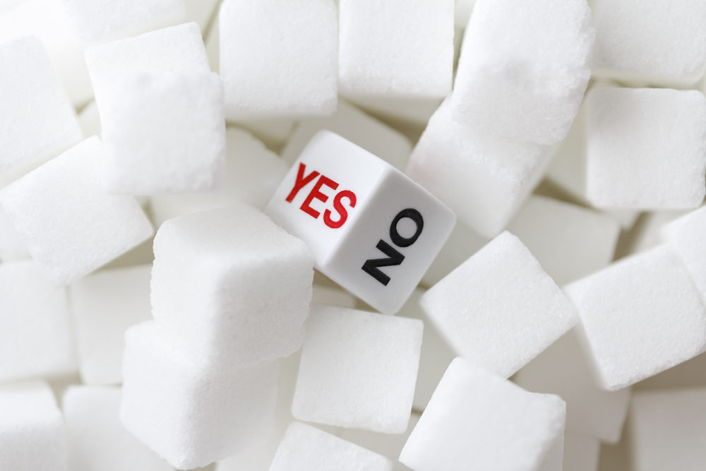 Sugar lumps with a dice in the middle with the options of yes or no
