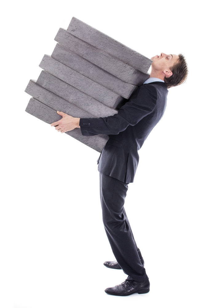Man carrying pile of paving stones