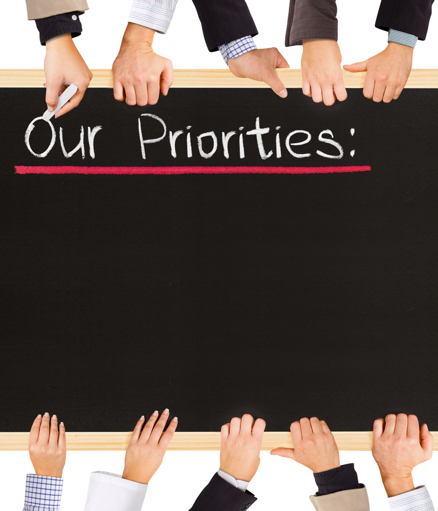 Blackboard with chalk writing saying "Our Priorities"