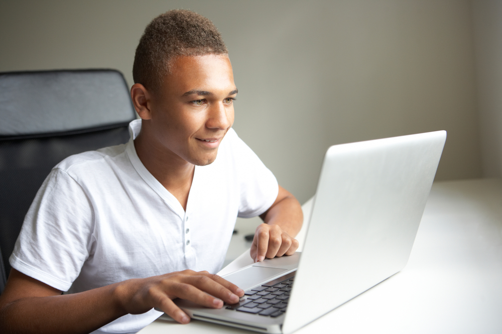 Teenage boy using laptop