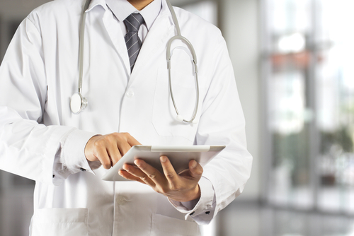 Doctor writing something on a tablet