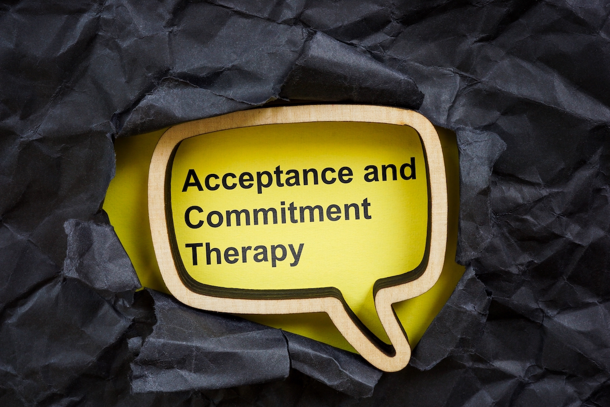 Acceptance and commitment therapy. Torn dark paper and speech bubble.