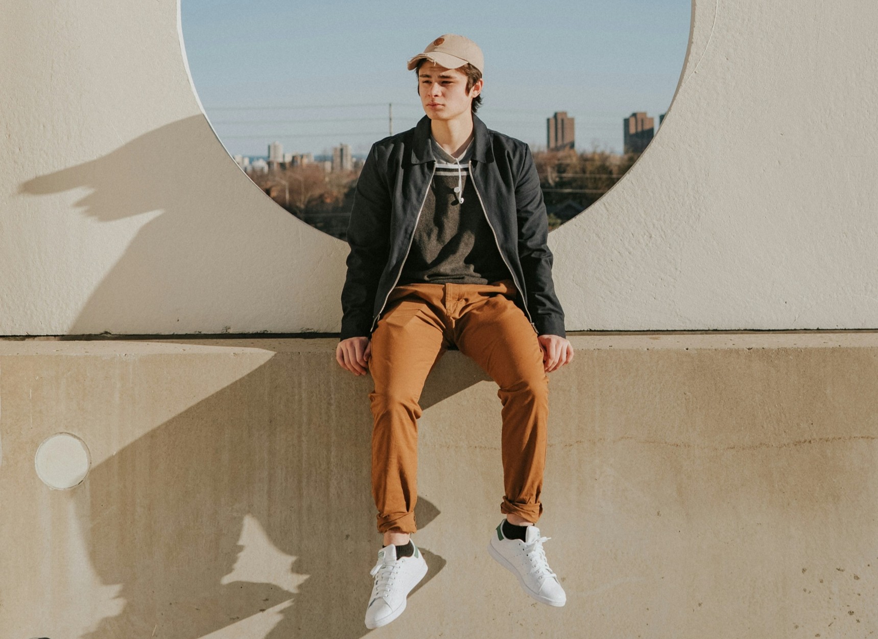 Young person sitting on a wall