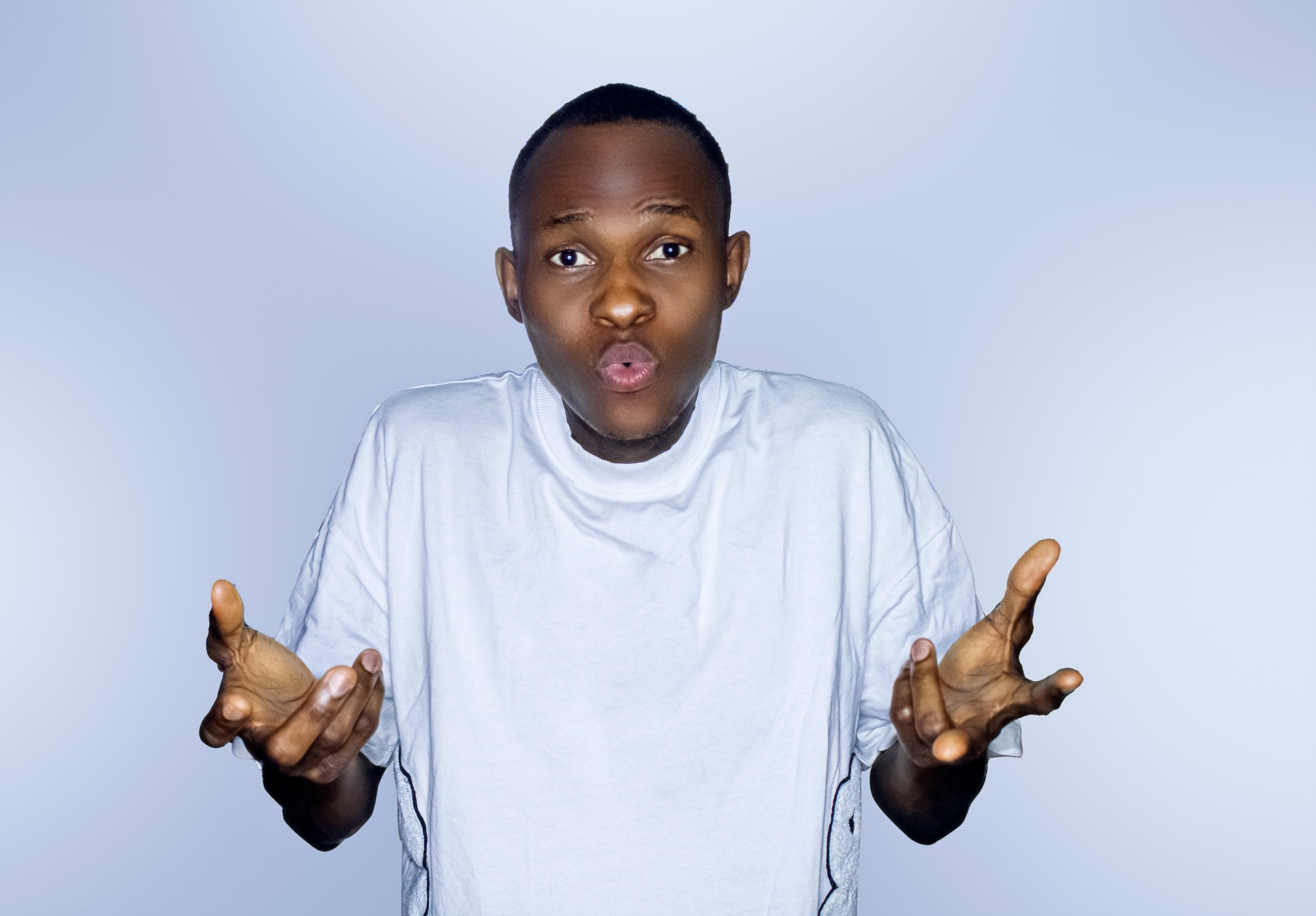 A person hold up their hands in a questioning stance