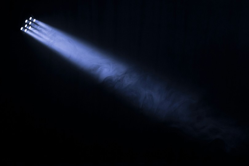 Spotlights light up a dark setting