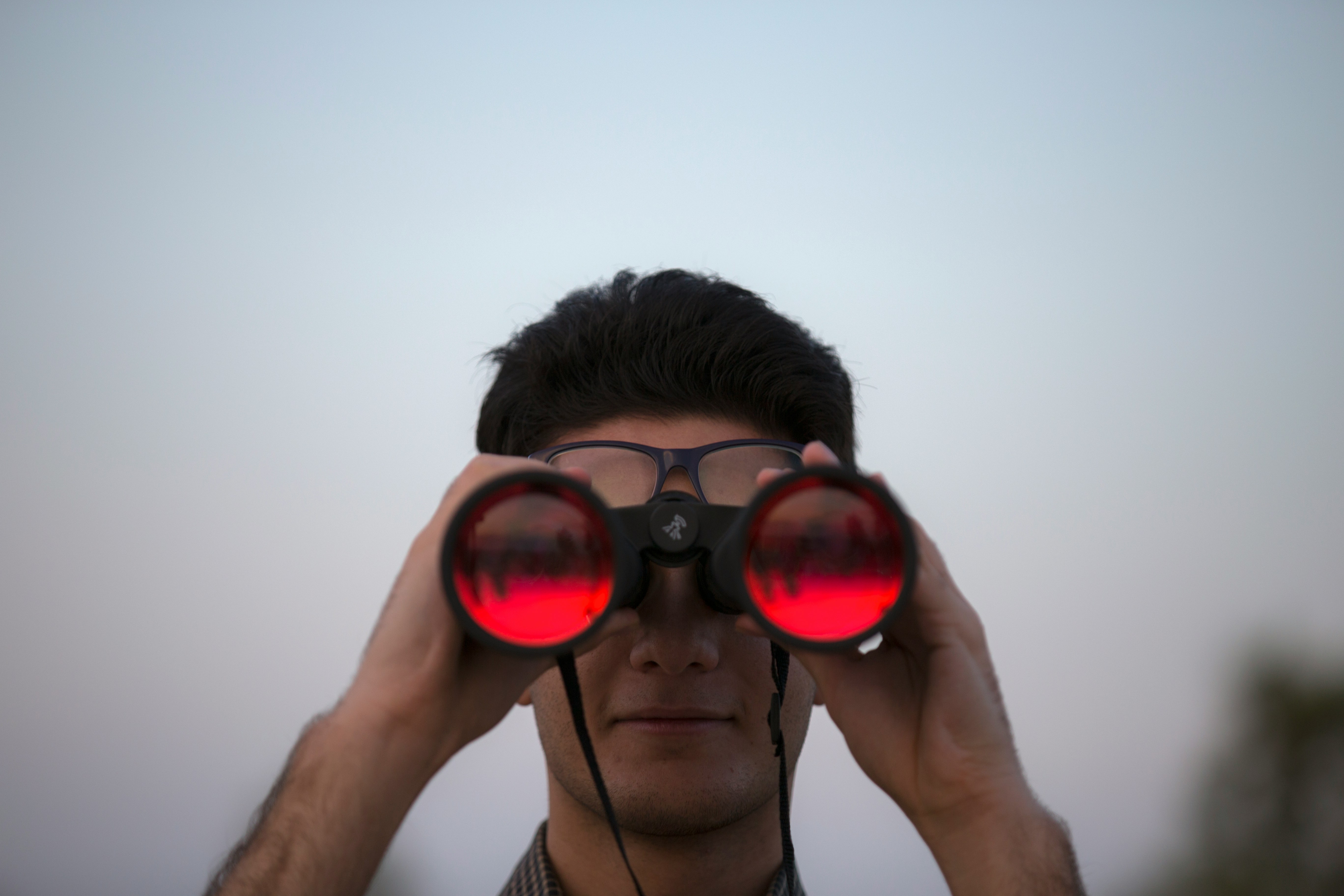 A person looking through binoculars